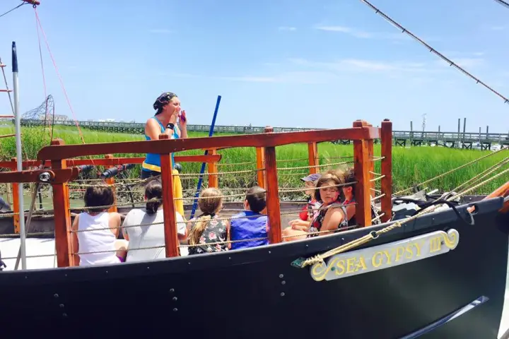 A group of kids listening to the crew member give instructions