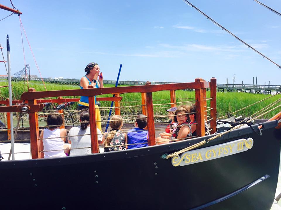 A group of kids listening to the crew member give instructions